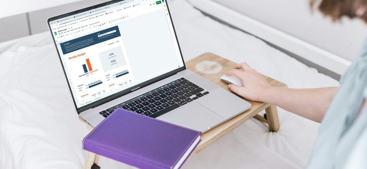 a person using a laptop on a bed